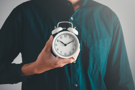 Time managment concept. Business man hold the clock . Work management concept.の写真素材