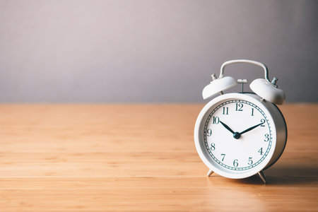 Clock isolate on the wooden table. Time managment concept and Work management concept.の写真素材