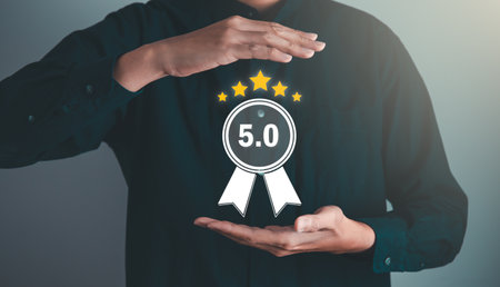 Businessman give the 5 star for best quality score, product warranty, ISO standard and quality assurance concept.の写真素材