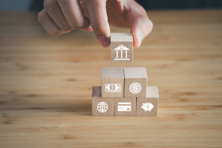 Wooden block of financial with money and bank icons.business financial and money saving concept.の写真素材