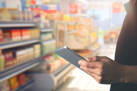 Businessman using tablet for checking stock with blur supermarket background. shopping online and business idea concept.の写真素材