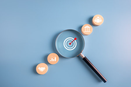 business goal achievement and objective concept.magnifier glass focus dart board icon with business icons background.の写真素材
