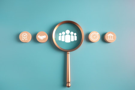business successful management and corporate collaboration cocept. magnifier glass focus teamwork icon with wooden block of business icons background.の写真素材