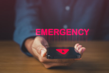 Urgent Emergency Alert Phone for Rapid Response. phone on the table with emergency and alert icon. Accident and Dial hotline 911 concept.の写真素材