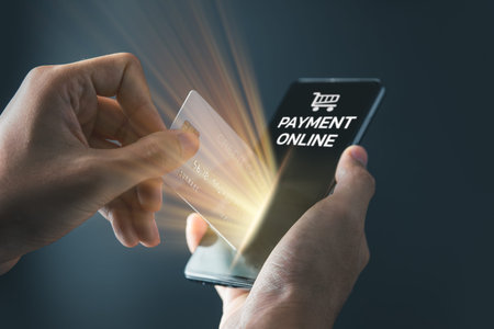 Businessman using mobile phone and credit card with shopping cart icon for shopping online and...