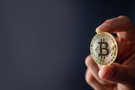 Bitcoin Blockchain Technology and Cryptocurrency. Hand holding bitcoin for Digital Finance and trading concept.の写真素材