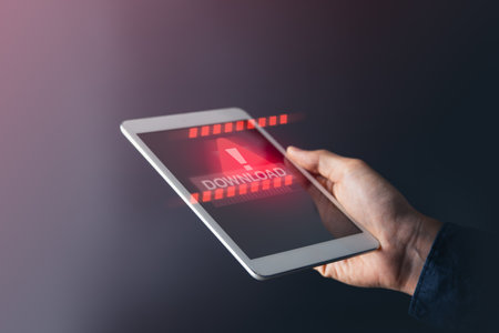 Businessman using tablet with red warning alert screen. System alert for virus,spam,scam and phishing. Cyber security, data security system concept.の写真素材