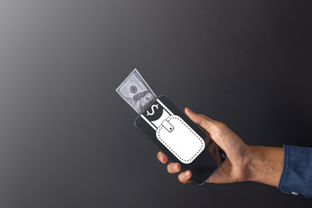 Global Economic and exchange rate on currency stock market. business man holding banknote and using phone  for US dollar index concept.の写真素材