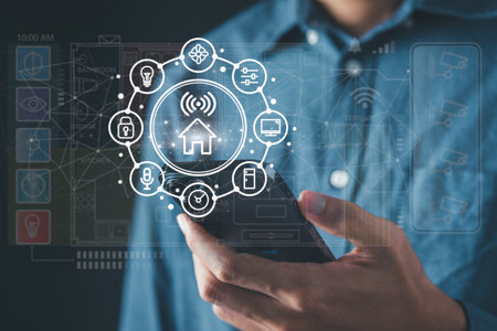 Man use smartphone to manage smart home features including security, lighting, and temperature. Smart home and Iot concept.の写真素材