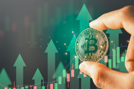 Hand holding bitcoin with graph and arrow background for Bitcoin Blockchain Technology and Cryptocurrency.の写真素材