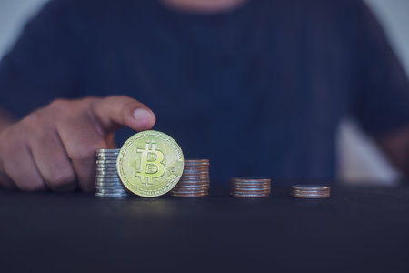 Man holding a gold Bitcoin. Make money with bitcoin, digital currency money investment concept,...