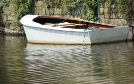 boat tied up on the bank of a riverの写真素材