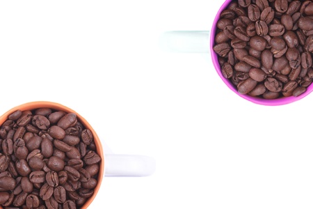 two coffee cups full of coffee beans situated on a white background.の写真素材
