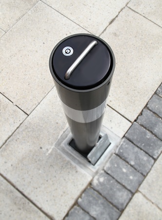 image of a brand new security bollard on a street used to stop access of vehicles in certain areasの写真素材