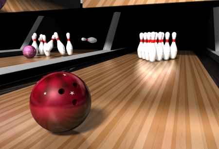 a red bowling ball rolling down a bowling alley ready to crash into skittles on a bowling alleyの写真素材