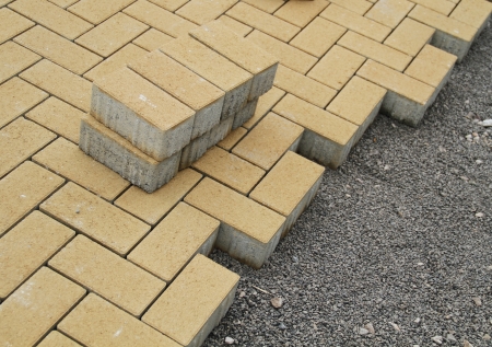 the process of laying brick down in a pattern to create brick road の写真素材
