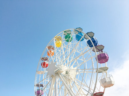 White ferris wheel with colorful sky
