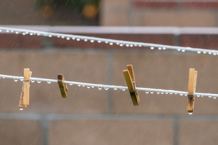 Heavy rain water drops on clothespinの写真素材