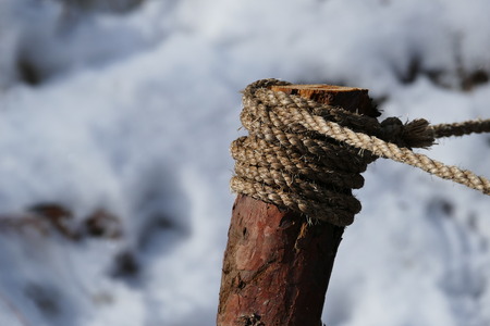 Wood with rope on top and snow background, Yosmiteの写真素材