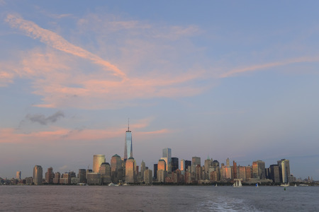 New York City skyline during sunset with red cloudsの写真素材