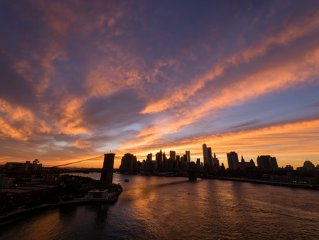 Sunset with Brooklyn Bridge and the New York City skylineの写真素材