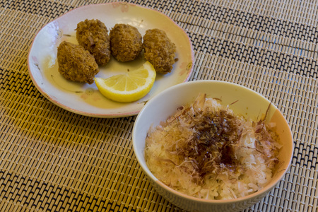 Putting the Dried Skipjack Tuna over the rice to make the traditional Japanese food - Cat Riceの写真素材