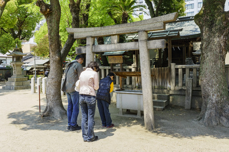 Osaka, APR 29: Family worshipping at old historical temple on APR 29, 2011 at Osaka city, Japanのeditorial素材