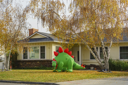 Temple City, DEC 12: Inflatable dinosaur christmas decoration and fall color in front of a house on DEC 12, 2016 at Temple City, Californiaのeditorial素材