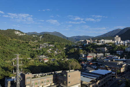 Beautiful mountain view with some building and blue sky at Taipei, Taiwanの写真素材