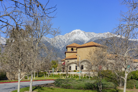 Beautiful snowy Mount Baldy with some building below, view from Rancho Cucamongaのeditorial素材