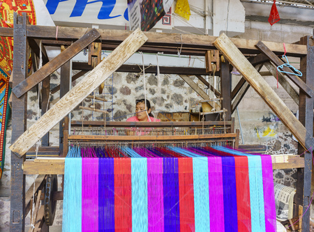 Teotihuacan, FEB 17: Woman weaving cotton in an old traditioan machine on FEB 17, 2017 at Teotihuacan, Mexicoのeditorial素材