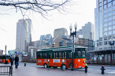 Boston, JAN 26: Orange and green Trolley Tour Bus on JAN 26, 2012 at Harvard Square, Boston, Massachusetts, Boston, United Statesのeditorial素材