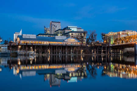 Sacramento, FEB 22: Night view of Sacramento skyline with Sacramento River on FEB 22, 2018 at Sacramento, Californiaのeditorial素材