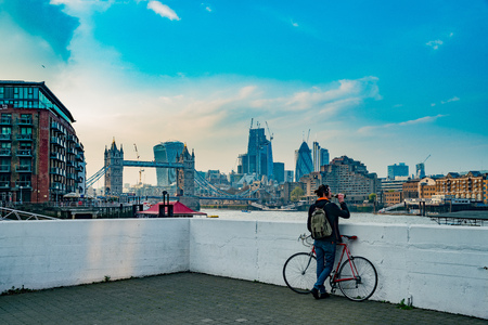 Londdon, APR 14: The historical and beautiful Tower Bridge with a man drinking beer underneath on APR 14, 2018 at London, United Kingdomのeditorial素材