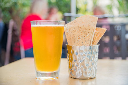 Cold beer and crisp biscuit on table