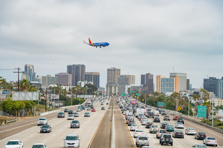 San Diego, JUN 29: Aerial view of the highway, Southwest Airline airplane landing and downtown on...