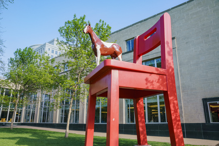 Big red chair and horse statue of the Denver Central Library in the Civic centerのeditorial素材