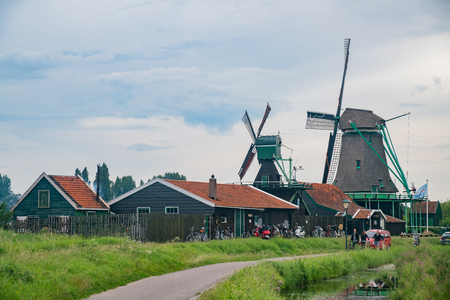 Zaandijk, JUL 22: De Bonte Hen, Klaverblad windmill and Dutch houses on JUL 22 at Zaandijk, Netherlandsのeditorial素材