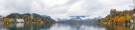Beautiful autumn landscape around Lake Bled with St. Martin's Parish Church and ships, castle and island at Sloveniaのeditorial素材