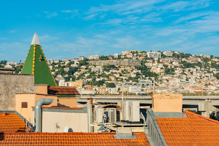 Morning view of a green and red roof with highway traffic and residence on mountain at Nice, Franceの写真素材