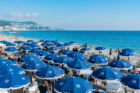 Nice, OCT 20: The beautiful Nice beach with many visitor hiding in beach umbrellas on OCT 20, 2018 at Nice, Franceのeditorial素材