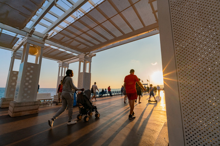 Nice, OCT 20: Sunset view of the beautiful Nice beach with many visitor walking around on OCT 20, 2018 at Nice, Franceのeditorial素材