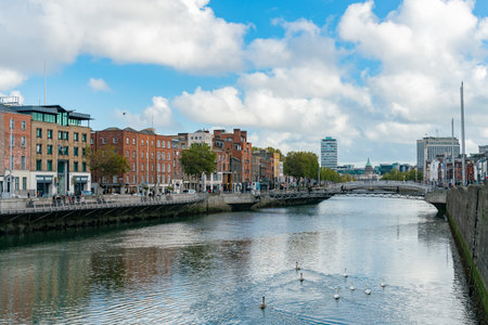 Dublin, OCT 28: Morning view of the famous Ha'penny Bridge with The Custom House behind on OCT 28,...