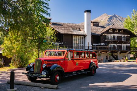 montana, AUG 27: Historical red travel car parked in front of the Lake McDonald Lodge on AUG 27, 2019 at Montanaのeditorial素材