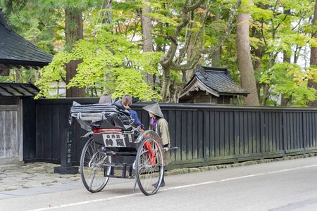 Kakunodate, OCT 21: Visitor sit in pulled rickshaw enjoying the view of Kakunodate Samurai House on OCT 21, 2019 at Kakunodate, Japanのeditorial素材