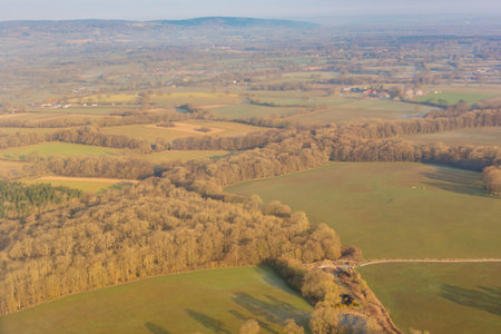 Aerial sunny view of rural landscape of UK from a window seat in an airplane