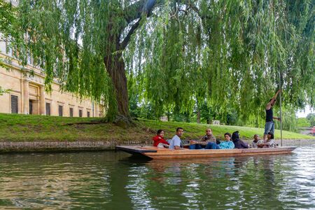 Cambridge, JUL 10: Student punting in the River Cam on JUL 10, 2011 at Cambridge, United Kingdomのeditorial素材