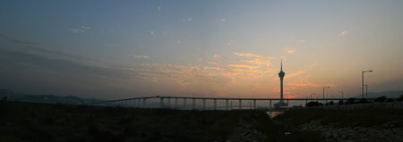 Sunset view of the Governador Nobre de Carvalho Bridge with the Macau Tower Convention and...