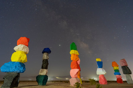Night starry sky with a beautiful milk way over Seven Magic Mountains at Nevada