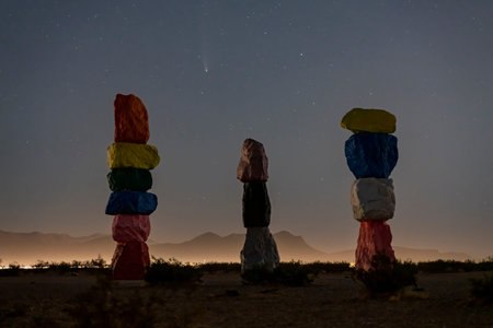 Night starry sky with the Comet NEOWISE over Seven Magic Mountain at Nevada
